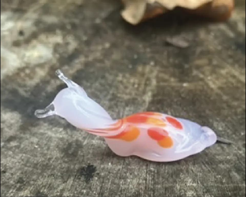 Glass slug with orange and pink trails